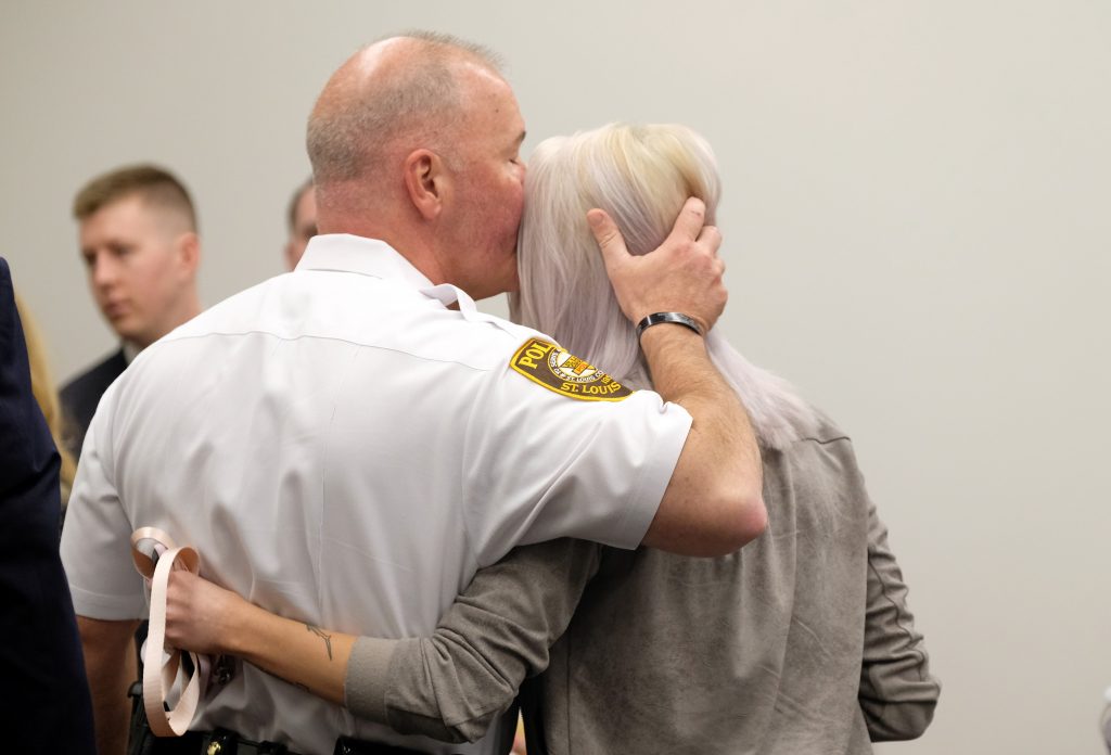 Elizabeth Snyder, right, is consoled by St. Louis County police chief Jon Belmar, left, following the sentencing for Trenton E. Forster Thursday, April 18, 2019, in Clayton. Forster, 20, was found guilty of first degree murder and sentenced to life in prison in the 2016 shooting death of St. Louis County police officer Blake Snyder. (AP Photo/Jeff Roberson)
