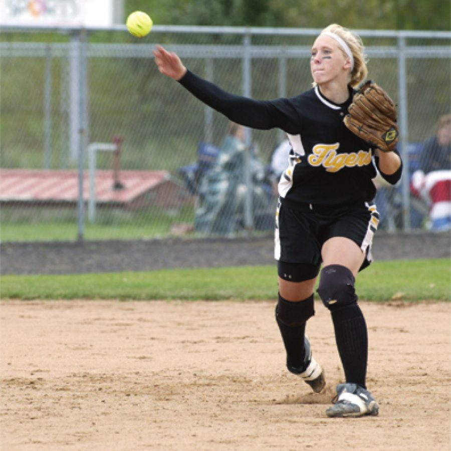 Oakville senior Ally Stanton, right, throws to first from her shortstop position during the state championship game.