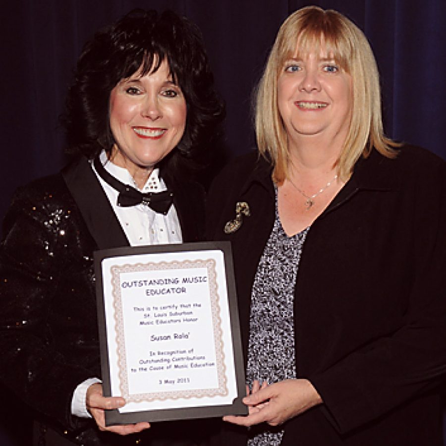 Lindbergh High School music instructor Sue Rola, left, receives the Outstanding Music Educator Award from St. Louis Suburban Music Educators board member Ann Geiler on May 3 during the LHS Spring Orchestra Concert.