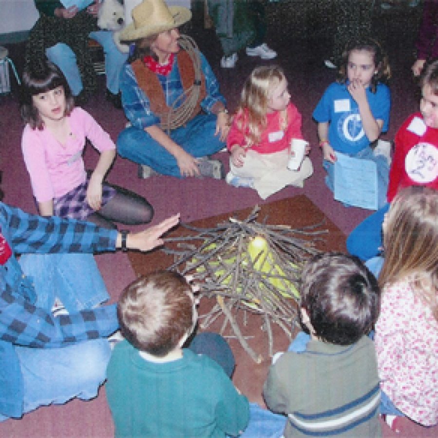 South Side Christian School pupils gather around the camp fire to hear the tall tales of Pecos Bill during a recent Scholastic Book Fair. Teachers wore costumes and decorated classrooms for the event.