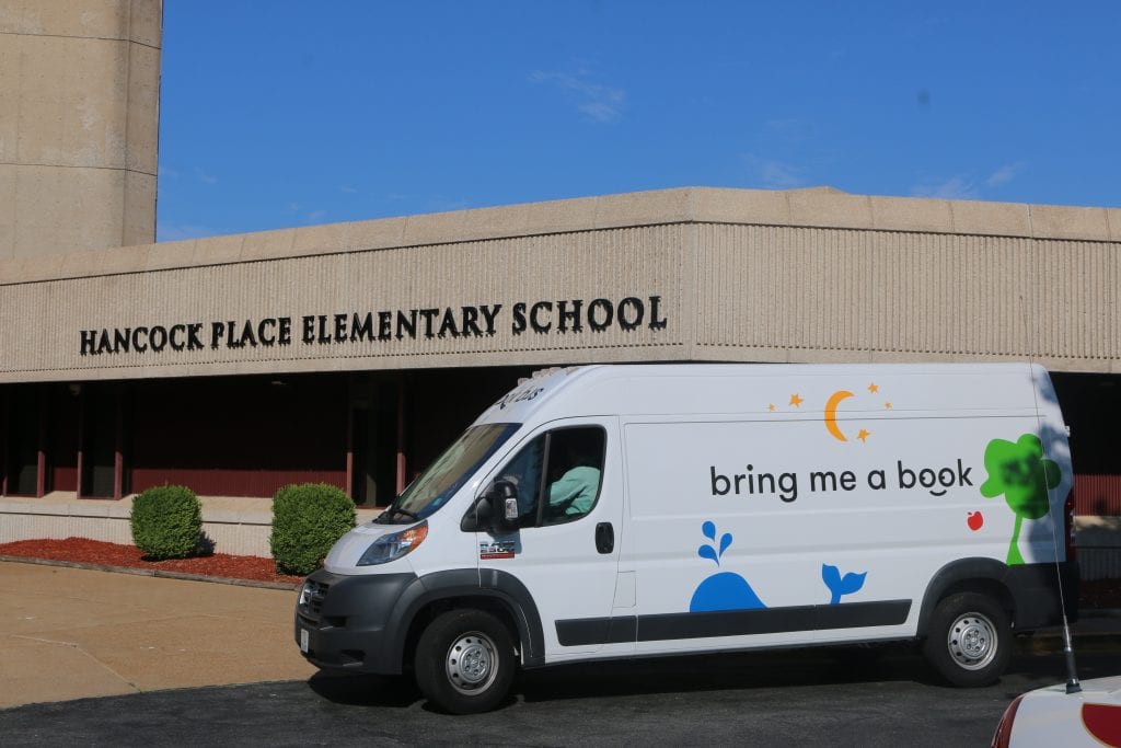 The Bring Me a Book Bus sits in front of Hancock Place Elementary