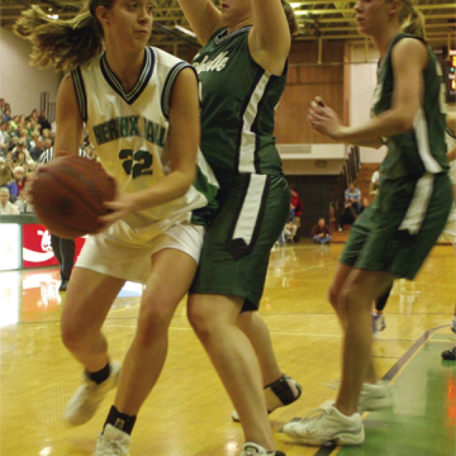 Nerinx Hall sophomore Molly Wersching, in the left photograph, pulls up for a shot against Mehlville defenders Alyse Gordon, center, and Alana Wuertz, right. Wersching of south county scored four points in the game.