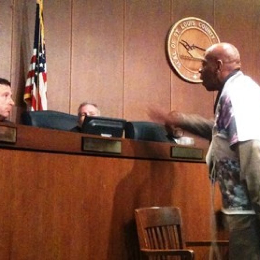 Justice for Mike Brown organizer Anthony Shahid, right, confronts Councilman Steve Stenger during the Sept. 16 County Council meeting.