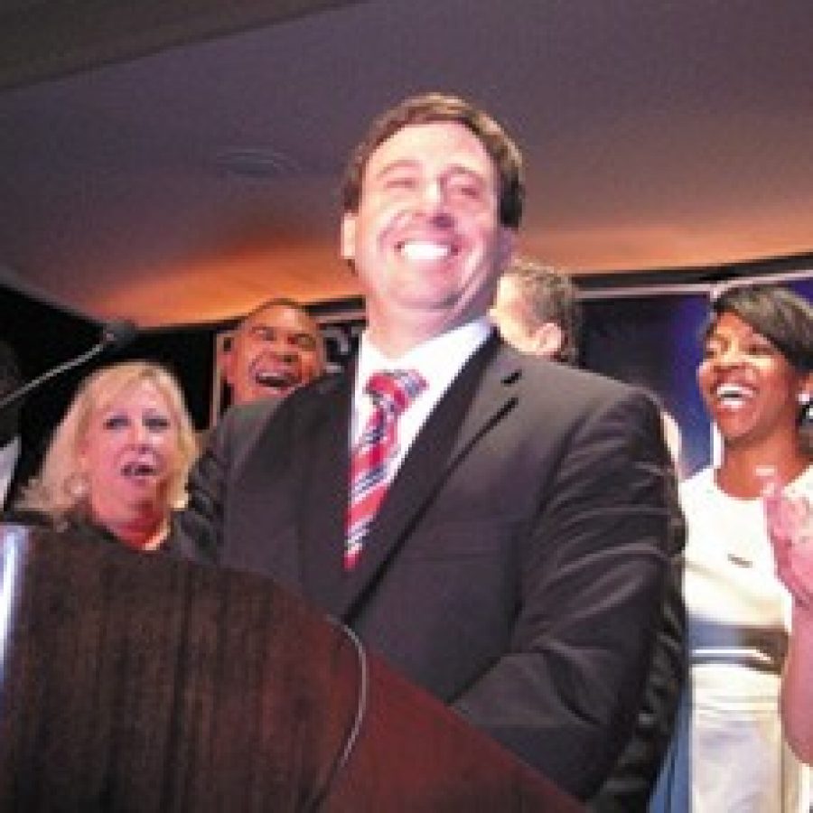 Sixth District Councilman Steve Stenger, D-Affton, promises his supporters at his victory party that he will restore their faith in county government. Pictured, front row, from left, are: 5th District Councilman Pat Dolan, D-Richmond Heights, who won re-election; Stengers sister Debbie Mourning; Stenger; Leslie Broadnax; Stengers wife Allison; and former Sen. Betty Thompson.