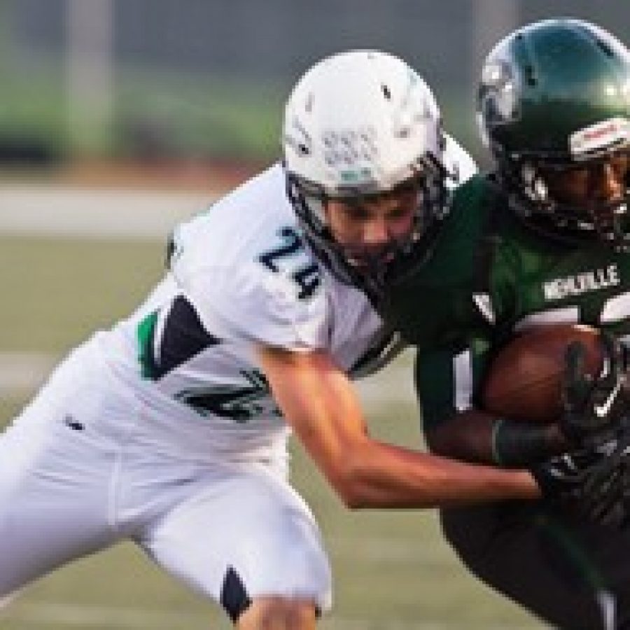 Marquette's Turner Cook, left, attempts to take down Mehlville's Tradell Cunningham in Friday night's game. Photo by Megan LeFaivre-Zimmerman
 