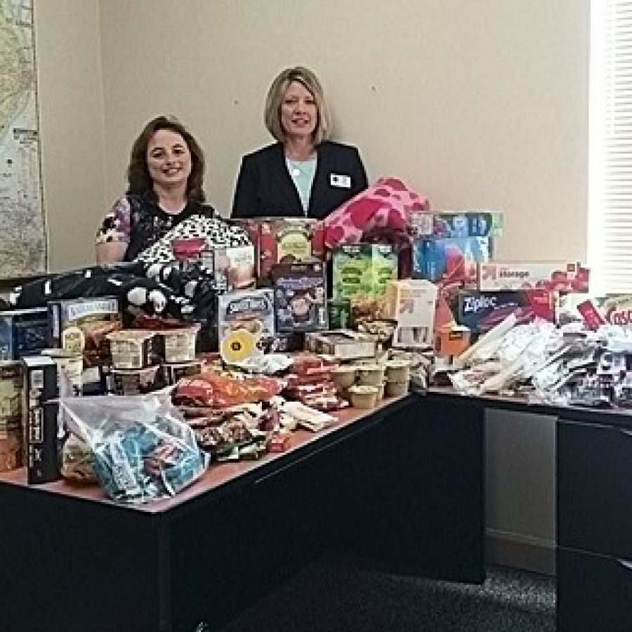 Coldwell Banker Gundaker independent sales associates Angela Hammond, left, and Kelly Barger are shown with an array of comforts-of-home items they collected in the community for Ronald McDonald Family Rooms.