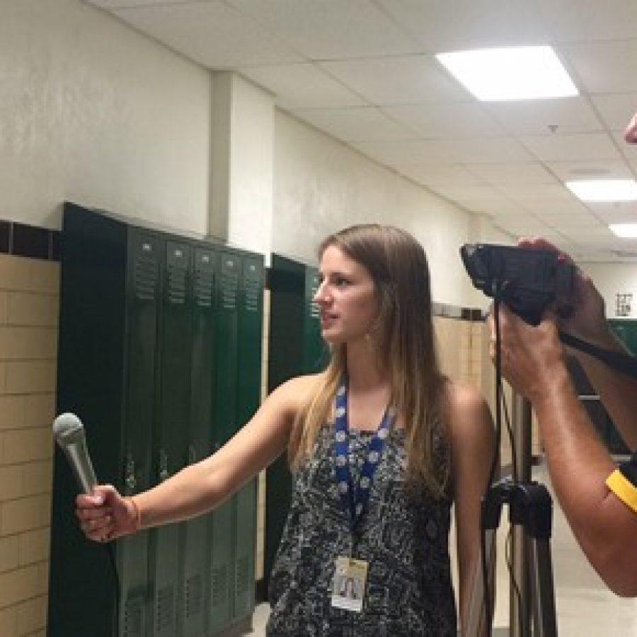 Oakville High School journalism student Hannah Hoffmeister, center, interviews Mark Haefner, left, at Mehlville High School last week after his speech to parents in support of Proposition 
R, as OHS journalism teacher Jeff Kuchno films.