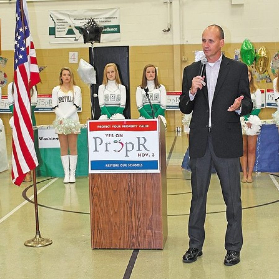 Pictured above, Superintendent Chris Gaines asks supporters at Saturdays rally for Prop R to help him get out the vote so that he can hire reading coaches and keep experienced teachers in the district. Behind him are the Mehlville HIgh School Pantherettes and the Oakville High School Golden Girls.