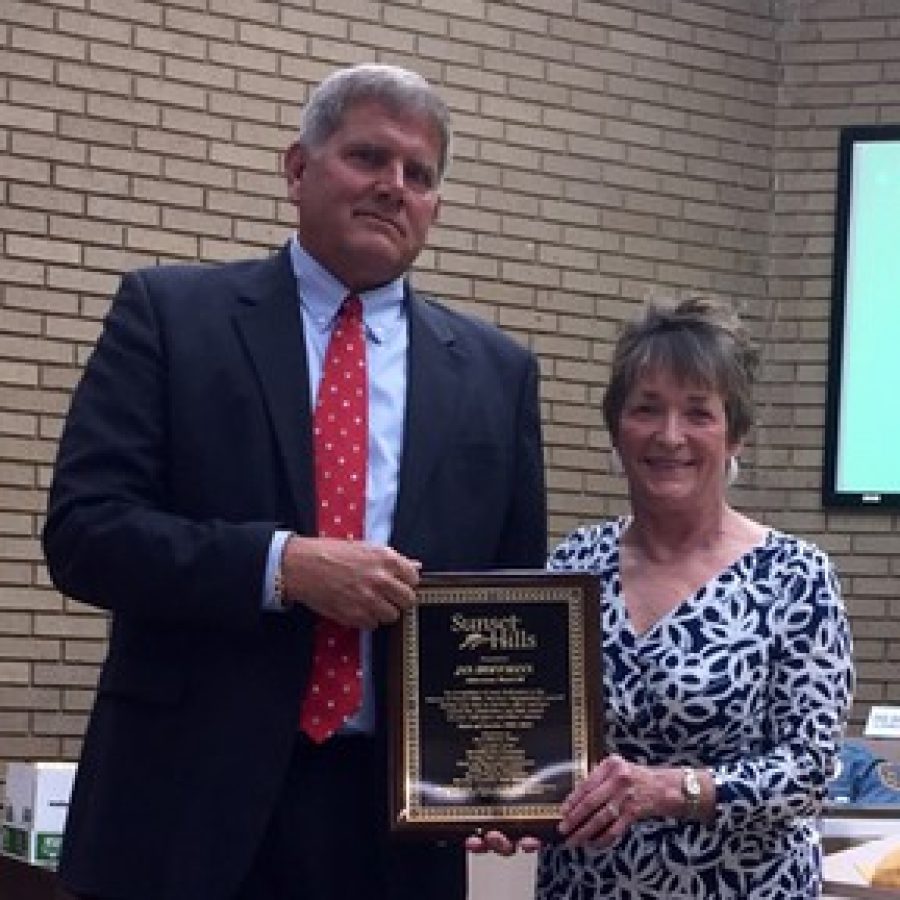 Mayor Mark Furrer, left, presents former Ward 3 Alderman Jan Hoffmann, right, a proclamation from the city honoring her the night she left the board April 28.