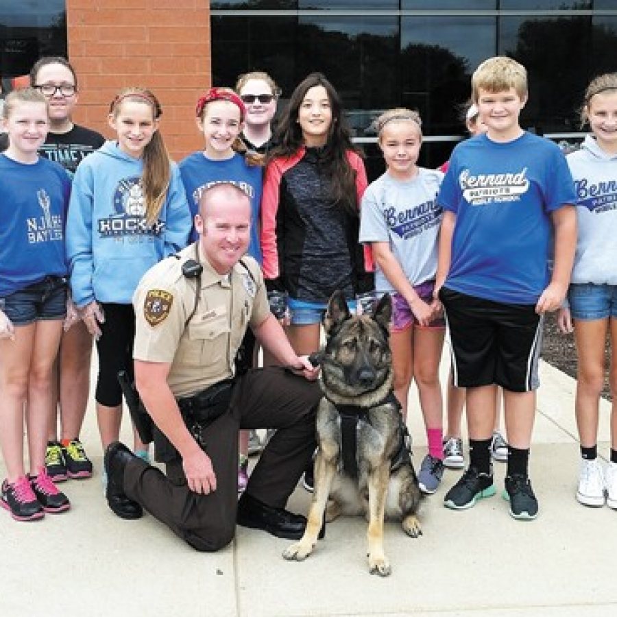 Some of the Bernard students who served first responders lunch last week are pictured with St. Louis County Police Officer Andy Hammel and his K-9 dog, Ivan, who attended the lunch.