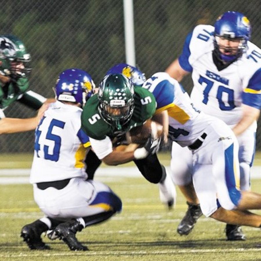 Mehlville Highs Jabari Shelton, No. 5, is tackled by Seckmans Brett Winder, No. 45, and Jordan Liescheidt, No. 34, in Friday nights game. Also pictured are Mehlvilles Jason Landwehr, No. 64, and Seckmans Jacob Vogel, No. 70.