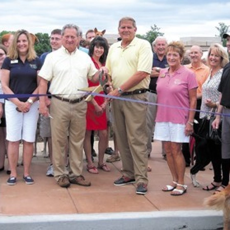 Crestwood Mayor Gregg Roby, middle left, and Sunset Hills Mayor Mark Furrer, middle right, open the cities joint dog park, Kitun Park, last June.