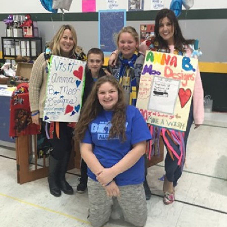 Sperreng Middle School sixth-grader Anna Stetzel, front center, blue shirt, sold handmade scarves at the Lindbergh Lacrosse craft fair in October, to help grant a Disney Make-a-Wish for her friend Bella.