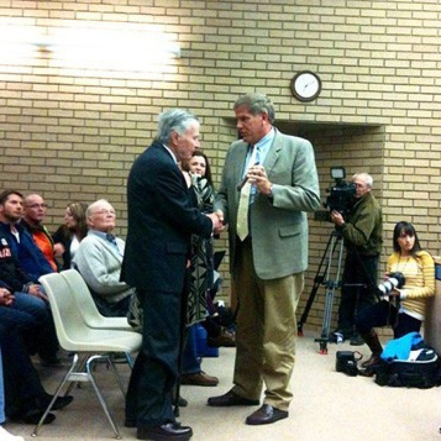 Mayor Mark Furrer presents an award during a November 2014 Board of Aldermen meeting, as the bicyclist he allegedly hit with his car, Randy Murdick, in orange third from left, watches. Photo by Gloria Lloyd.