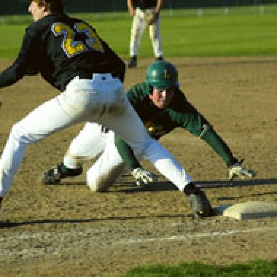 Lindberghs Scott Hicks 35 dives safely back to first as Lafayette first baseman Chris Hicks waits for the throw from pitcher Bill Allerdissen.
Bill Milligan photo 