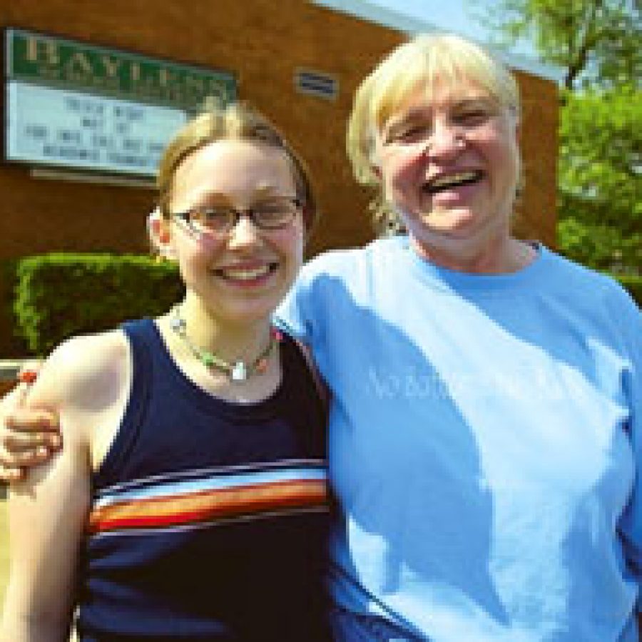 Sarah Blackey, left, and her English teacher Annabel Blackiston Haskett enjoy a laugh outside Bayless High School last week.
Bill Milligan photo
 