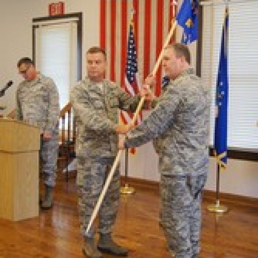 Brig. Gen. David Newman left hands the 157th Air Operations Group flag to Col. Richard Chapman as Chapman assumes command of both the 157th AOG and the Jefferson Barracks National Guard post in south St. Louis County on Saturday. Bill Phelan photo  