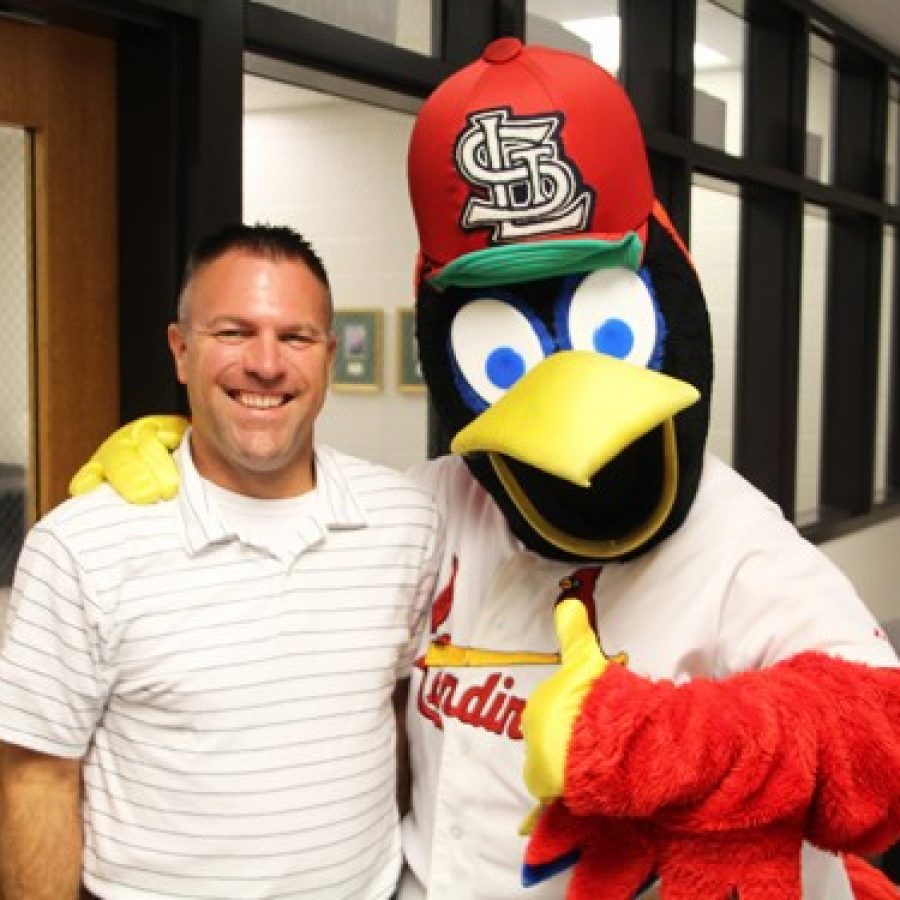 St. Louis Cardinals mascot Fredbird tips his cap as festivities