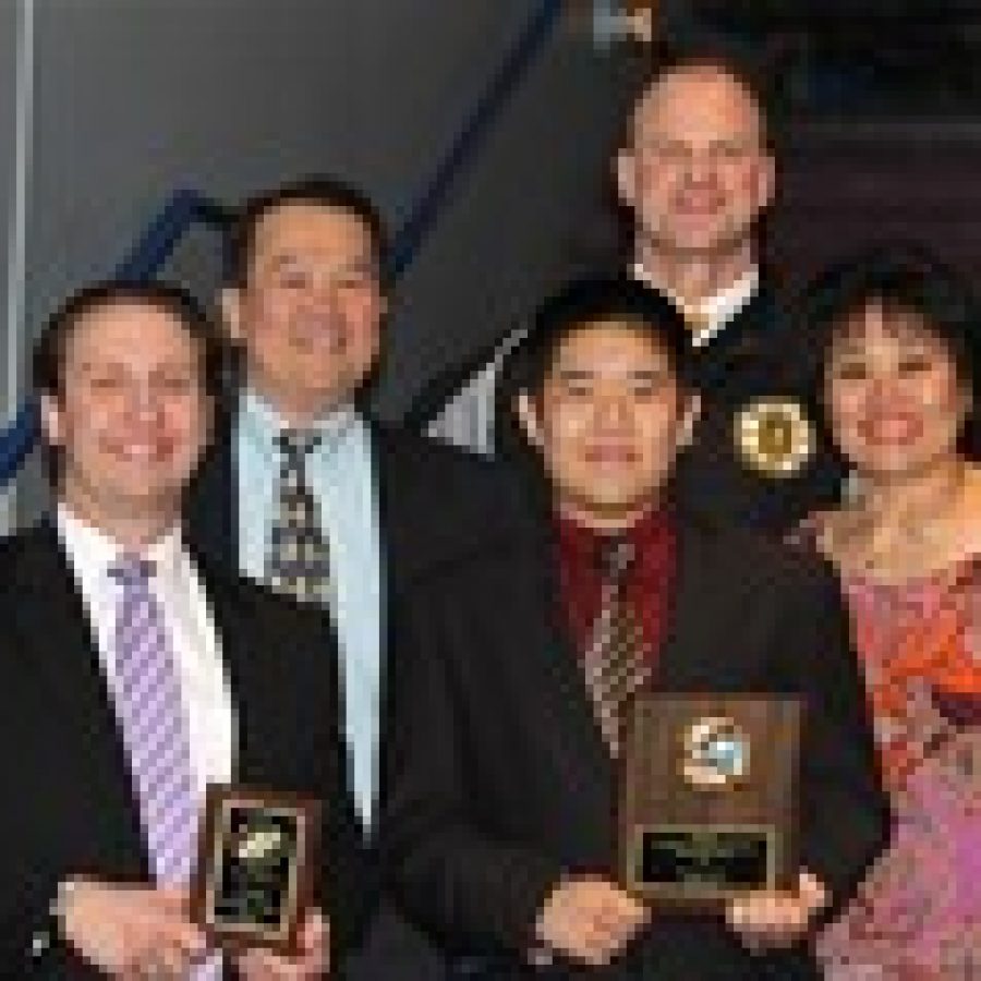 Benjamin Seah was presented the Mid-States Hockey Scholarship and Tigers head coach Derek Stephens was named Coach of the Year during an awards ceremony at the Mid-States Challenge Cup game. Pictured, from left, are: Stephens; Benjamins father, Francis Seah; Benjamin; and Benjamins mother; Jenny Seah. In the back row is Mick OHalloran, Tigers junior varsity development team head coach. 