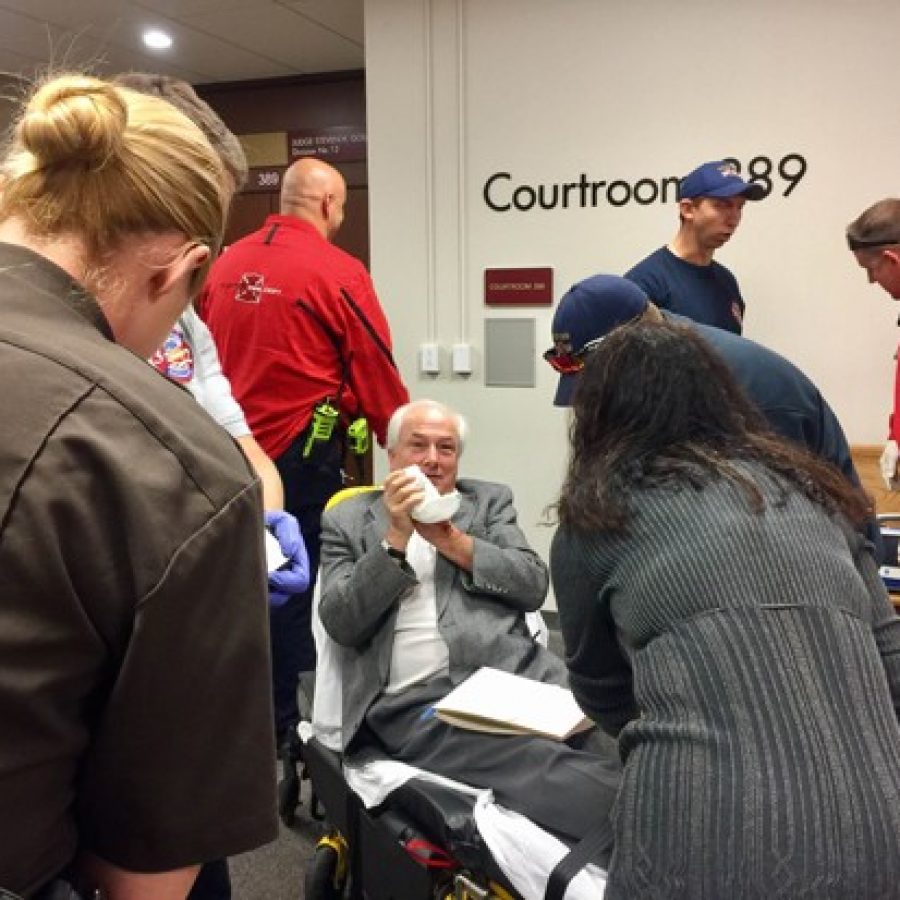 Clayton and Mehlville parademics assist reporter Tim ONeil, sitting, after losing part of a finger Nov. 9 at the St. Louis County Courthouse.