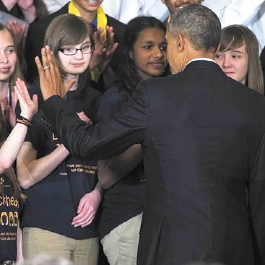 President Barack Obama high-fives Lindbergh Schools students at the White House Science Fair April 13. After testing an eco-friendly glue created by the Girl Scout troop from Sperreng Middle School, the president promised to follow their progress on their website. Pictured from left are: 'The Blockheads': Reagan Mattison, Christina Yepez, Sindhu Bala, Julianna Jones and Sydney Gralike.