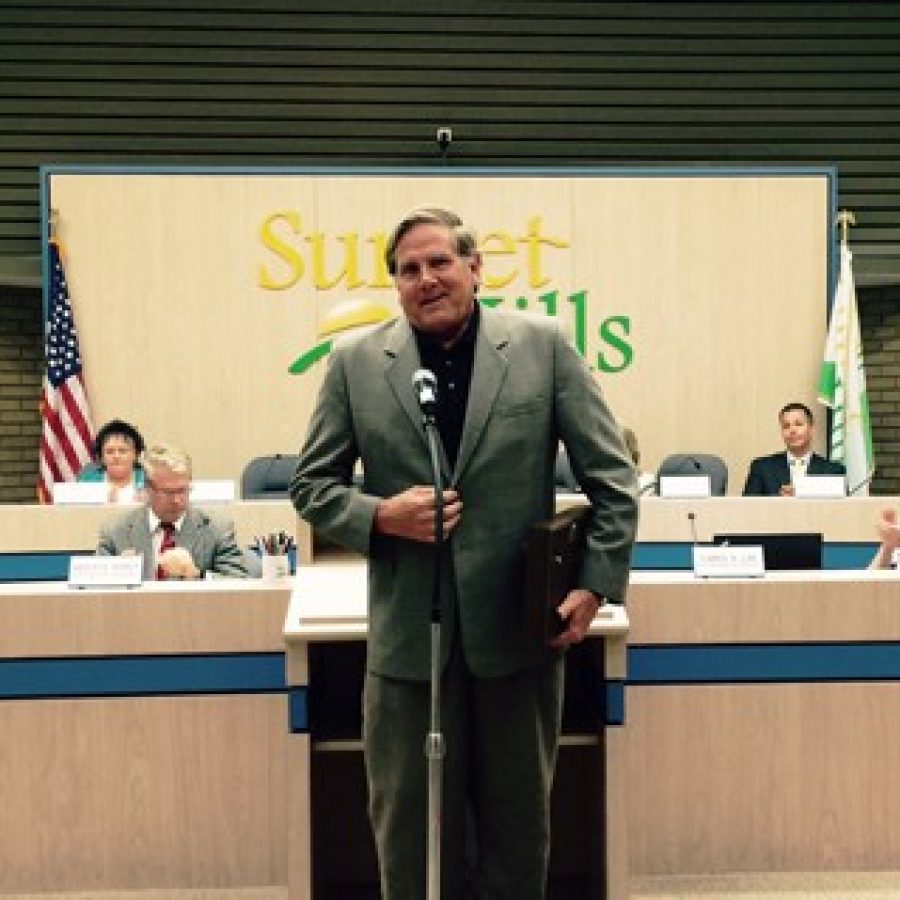 Sunset Hills Mayor Mark Furrer makes his final statements as mayor last week, promising to slip into obscurity. Pictured behind him are, left to right, incoming Mayor Pat Fribis, Ward 3 Alderman Keith Kostial, Ward 1 Alderman Dee Baebler, Assistant Engineer Wes Searcy, Ward 2 Alderman Steve Bersche, Court Administrator Carol Lay, Ward 1 Alderman Richard Gau and Ward 3 Alderman Kurt Krueger.