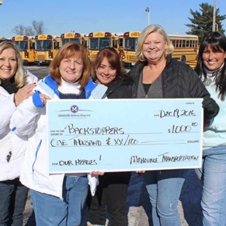 Mehlville Transportation Department employees, from left, Maxine Dillow, Pam Aguinaldo, Annette Kobermann, Sharon Mabrey and Dawn Klemp are shown with a blowup of a \$1,000 check for BackStoppers.