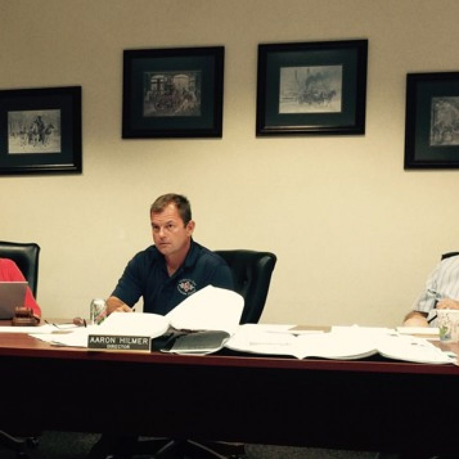 Mehlville Fire Protection District Board of Directors, from left, Treasurer Bonnie Stegman, Chairman Aaron Hilmer and Secretary Ed Ryan, listen to resident Bill Hogan bring his concerns about a proposed apartment complex at the Sept. 21 board meeting.