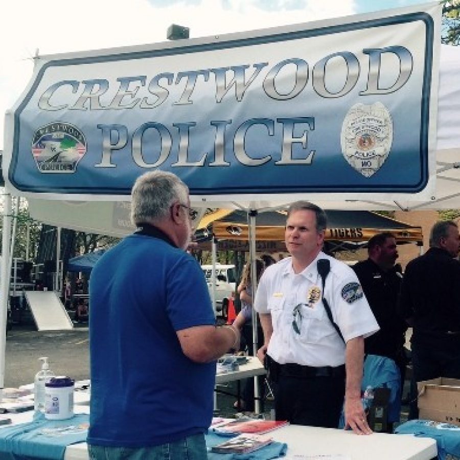 Crestwood Deputy Chief Ron Compton talks with a resident during the 'Food Truck Party at the Plaza' event Saturday.