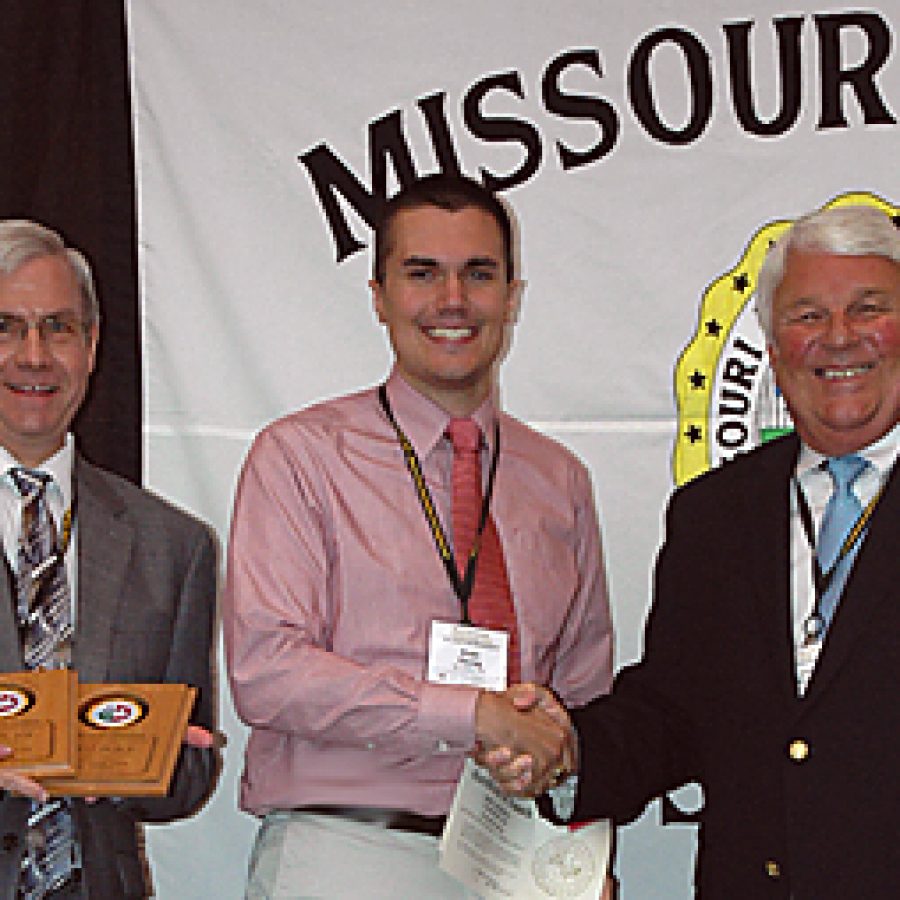 Call Newspapers Executive Editor Mike Anthony, left, and Staff Reporter Evan Young, center, accept the Calls 2011 Better Newspaper Contest awards from Joe May, Mexico Ledger publisher and Missouri Press Association president, during the associations annual banquet Sept. 10 in Branson.