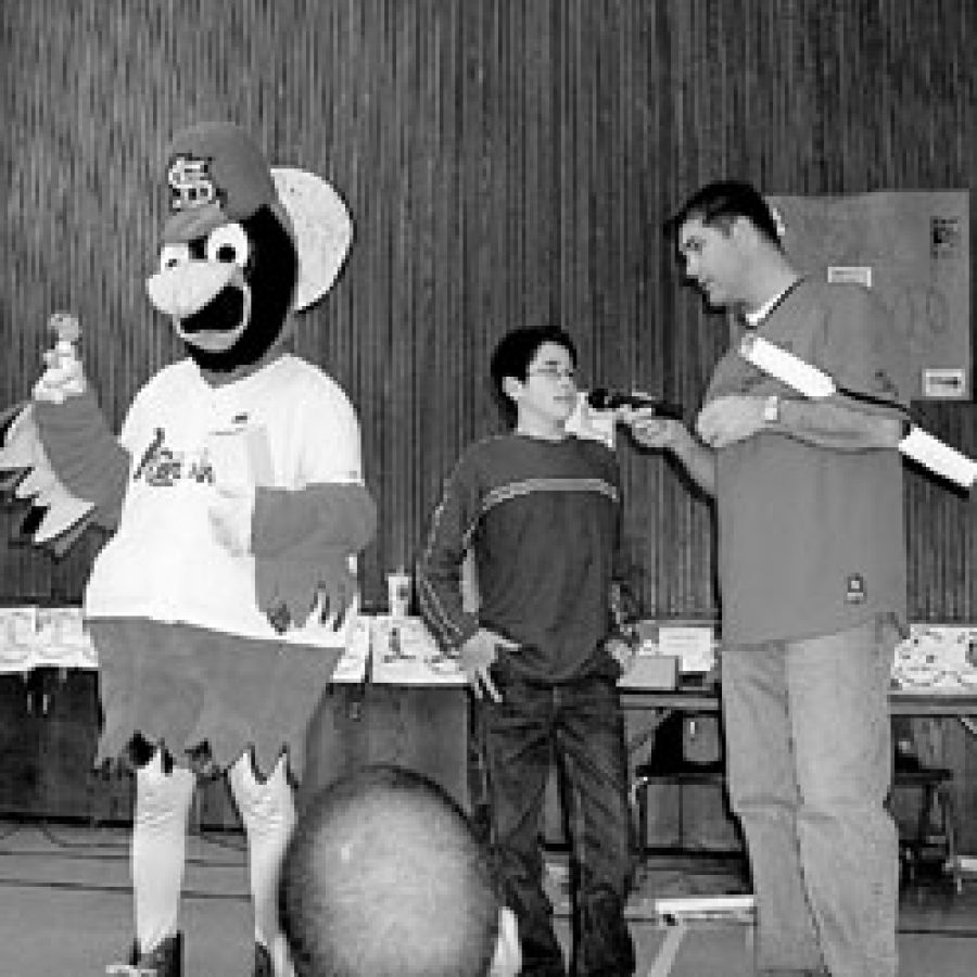Washington Middle School pupil Kyle Novak is shown with Fredbird and retired Cardinal pitcher Andy Benes during the Cardinal School Program.