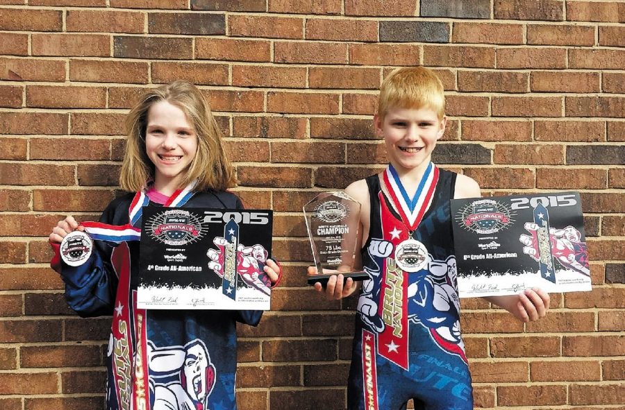 Kaylin Homfeld and her brother JP display the awards they won earlier this month at the Brute Nationals Wrestling Championship. In February, the two won state wrestling championships on the same day.