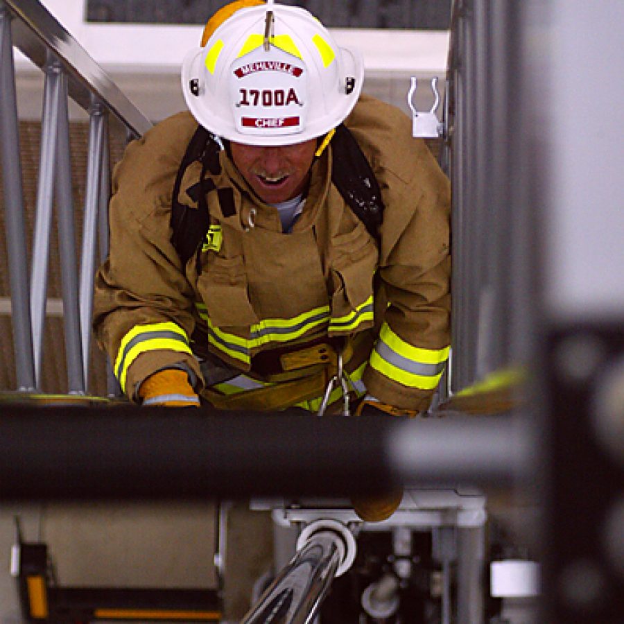 Administrative Chief Fire Officer Tim White climbs a 100-foot aerial ladder, one of the components of the Mehlville Fire Protection Districts revised fit-for-duty policy. Bill Milligan photo