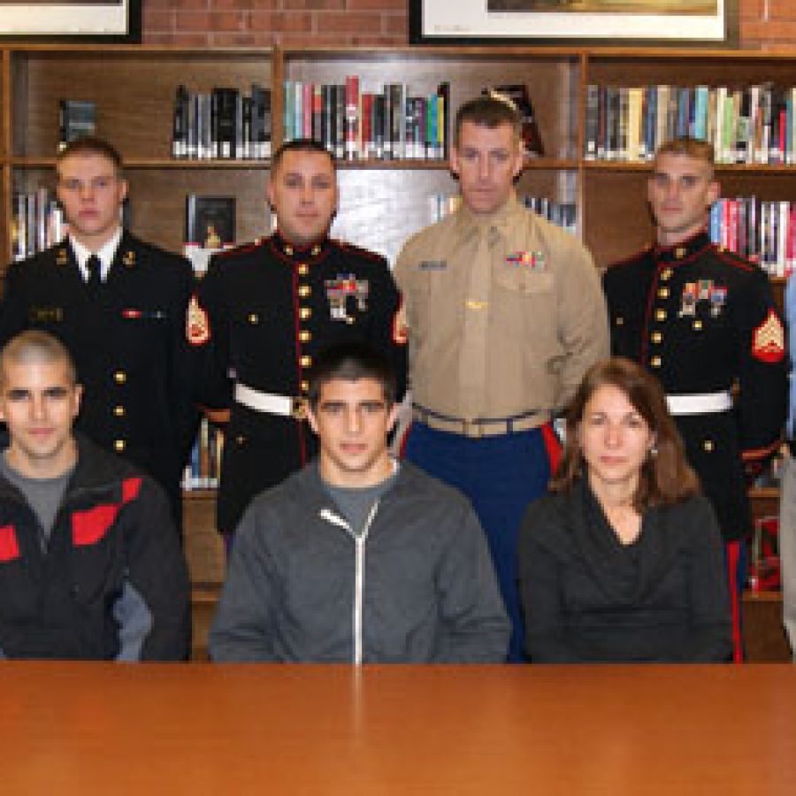 Oakville High School senior Nick Chinea was presented with a four-year scholarship to a college of his choice through the Navy Reserve Officers Training Program, or ROTC, Marine Corps Option. Pictured, back row, from left, are: OHS Principal Jan Kellerman, Austin Leicht, Staff Sgt. Ross Kaeding, Capt. David Klingensmith, Sgt. Ryan McCreary and OHS Assistant Principal Brian Brennan. Front row, from left, are: Zach Chinea, Nick Chinea and Charmaine Chinea.