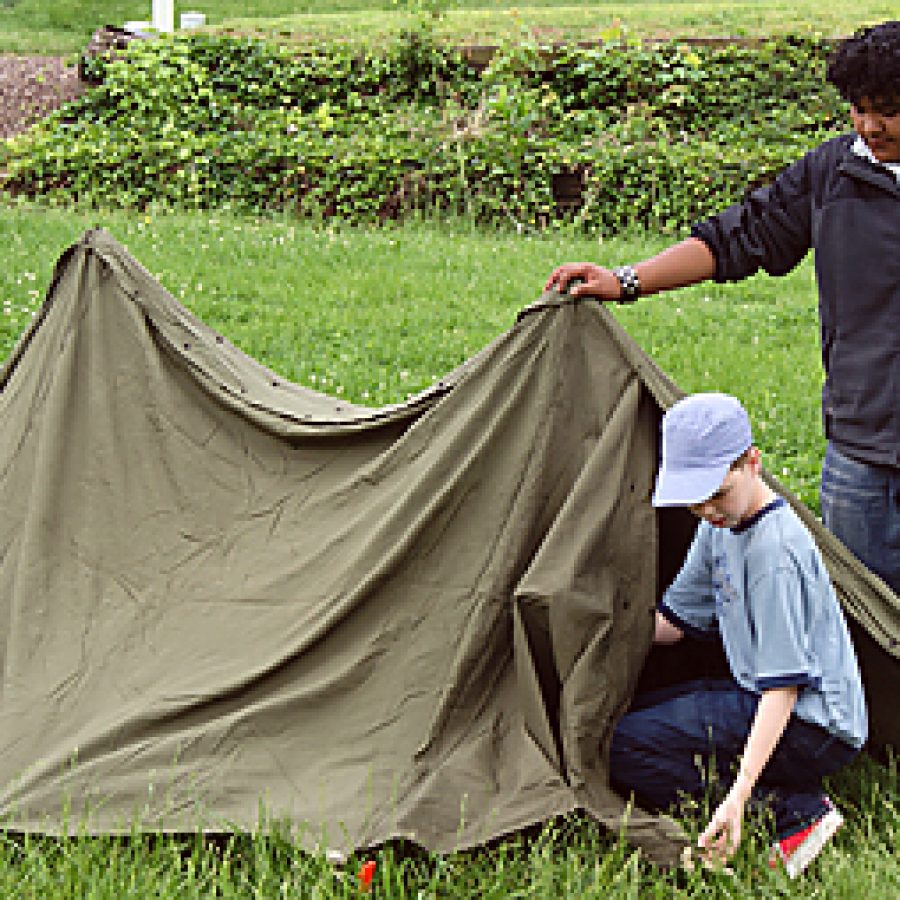 Margaret Buerkle Middle School seventh graders Logan Jacobs, left, and Jose Vasquez pitch a tent during the \Camp Life\ activity at the schools Civil War Day on May 13.