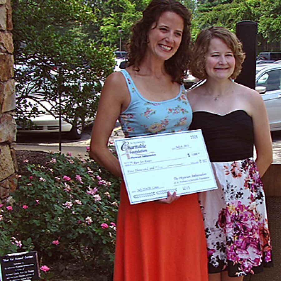 Colleen Caul, left, is pictured with her sister, Katie Rose, on July 6 in front of the \Run for Roses\ Garden at the St. Anthonys Medical Center Hyland Education and Training Center. The Physician Ambassadors of the St. Anthonys Medical Center Charitable Foundation dedicated the garden and presented a check in honor of Run for Roses, Cauls upcoming 65-day trek from St. Louis to New York City to raise funds for the Cystic Fibrosis Foundation. Katy Forand photo