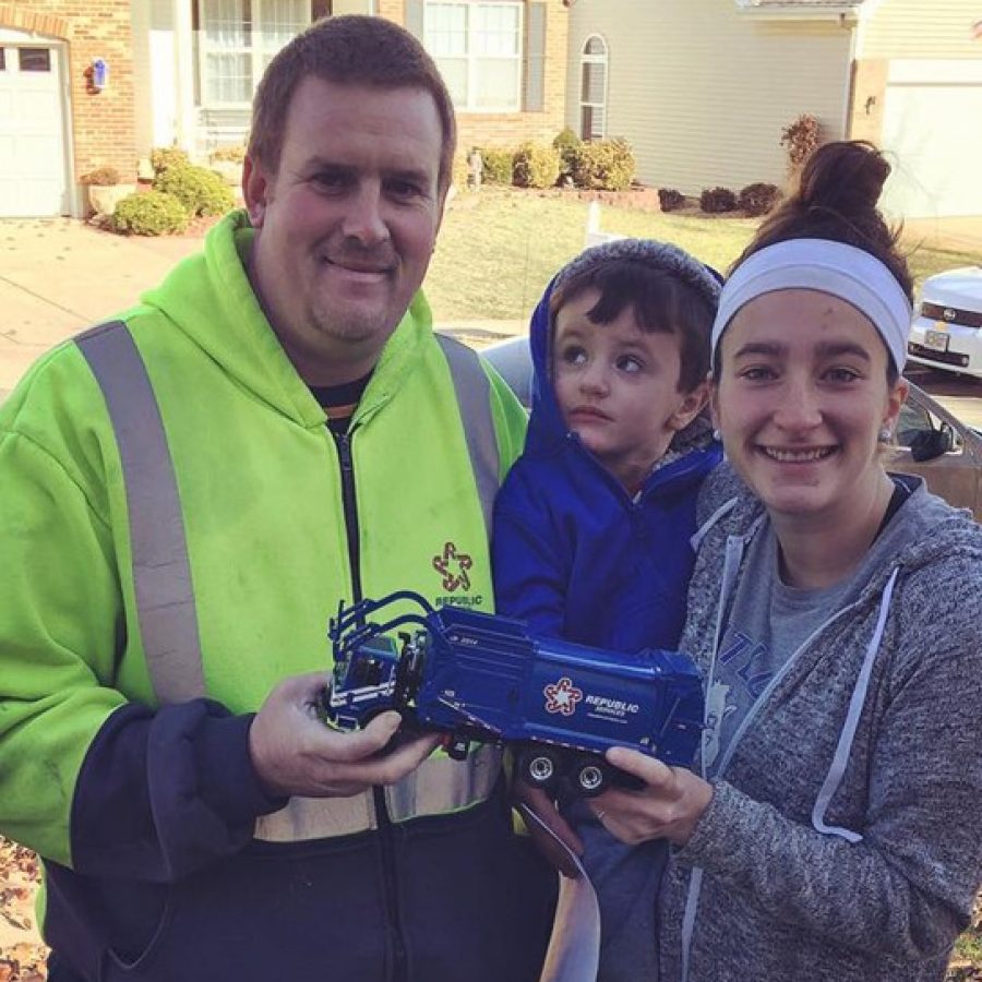 Fred Davenport, left, gave a mini trash truck to Sam Miskovic, left, for Christmas. Also pictured is Sams mother Annie Miskovic.