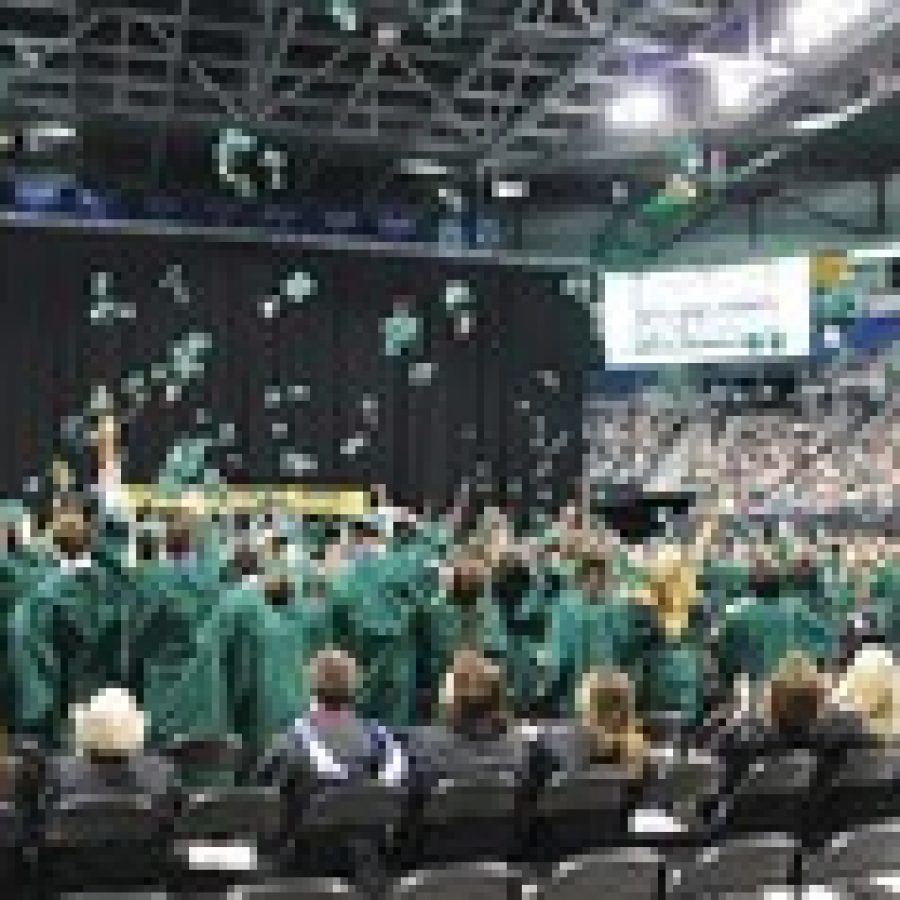 Members of the Lindbergh High School Class of 2013 toss their mortarboards in the air in celebration of graduation last week at Chaifetz Arena. 