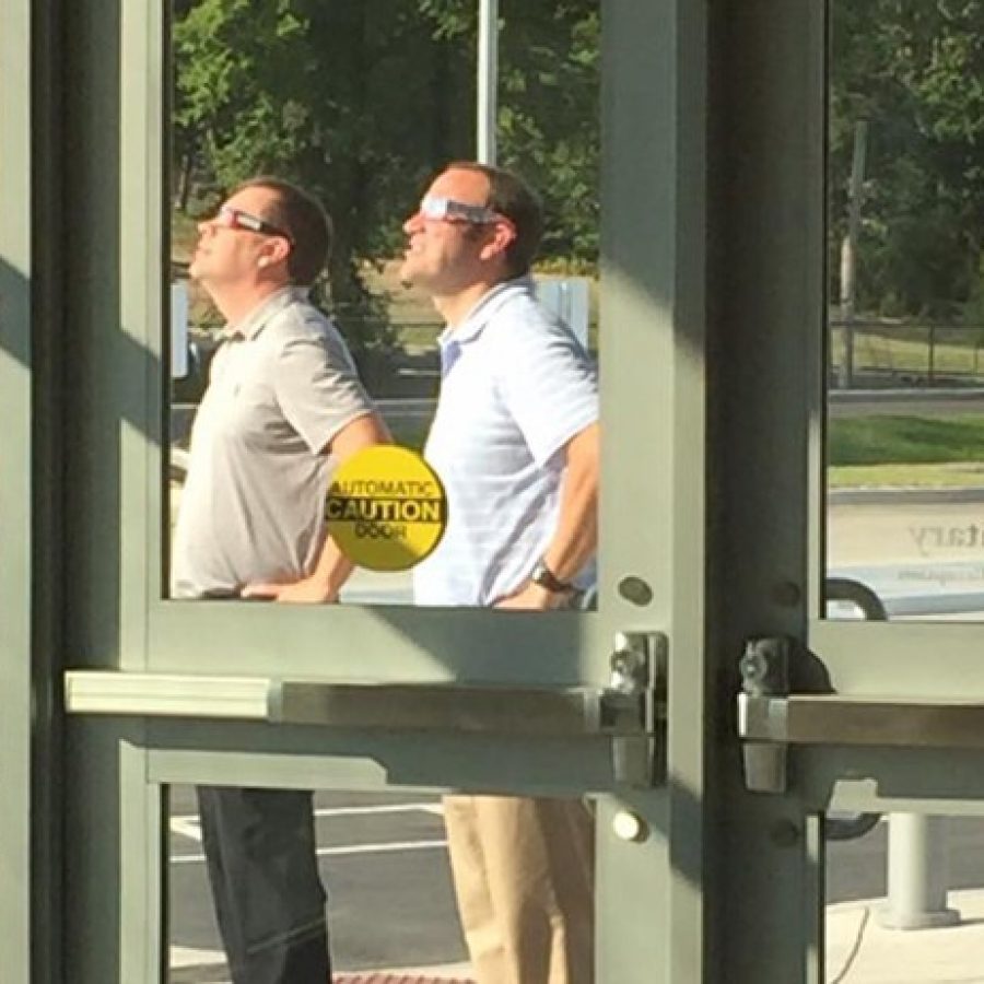 Lindbergh Schools Dressel Elementary Principal Craig Hamby, left, and Assistant Principal Patrick Schoenekase try out some of the schools eclipse glasses last week to see if they will stand up to the suns rays.