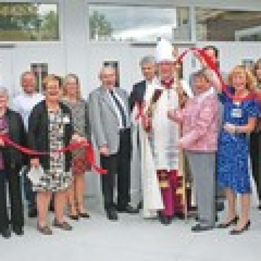 The Most Rev. Edward Rice is joined by Nazareth Living Center volunteer leaders, administrative staff and Paric Construction representatives at the grand opening of the independent living apartments of the Village at Nazareth. 
