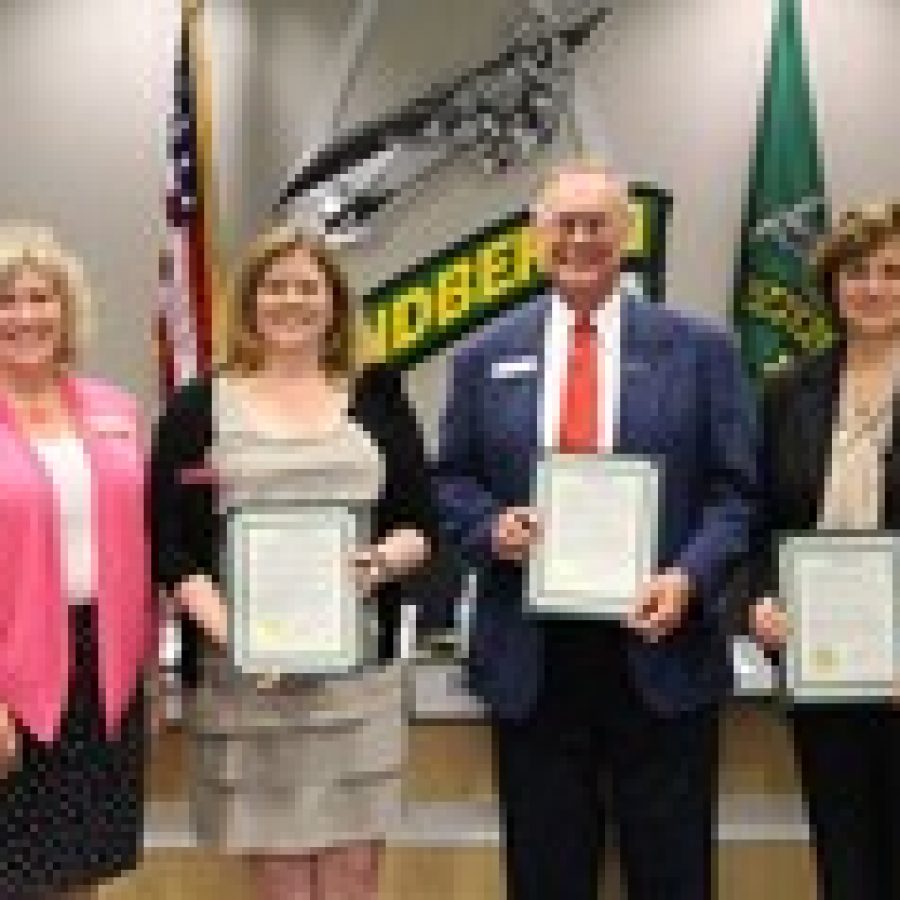 The Lindbergh Board of Education last week honored the four candidates who sought election to the board earlier this month. Board Vice President Kathy Kienstra, left, presented resolutions to candidates Kara Gotsch, Vic Lenz and Cindy McDaniel for volunteering to serve on the board. Candidate Adam McBride is not pictured. 