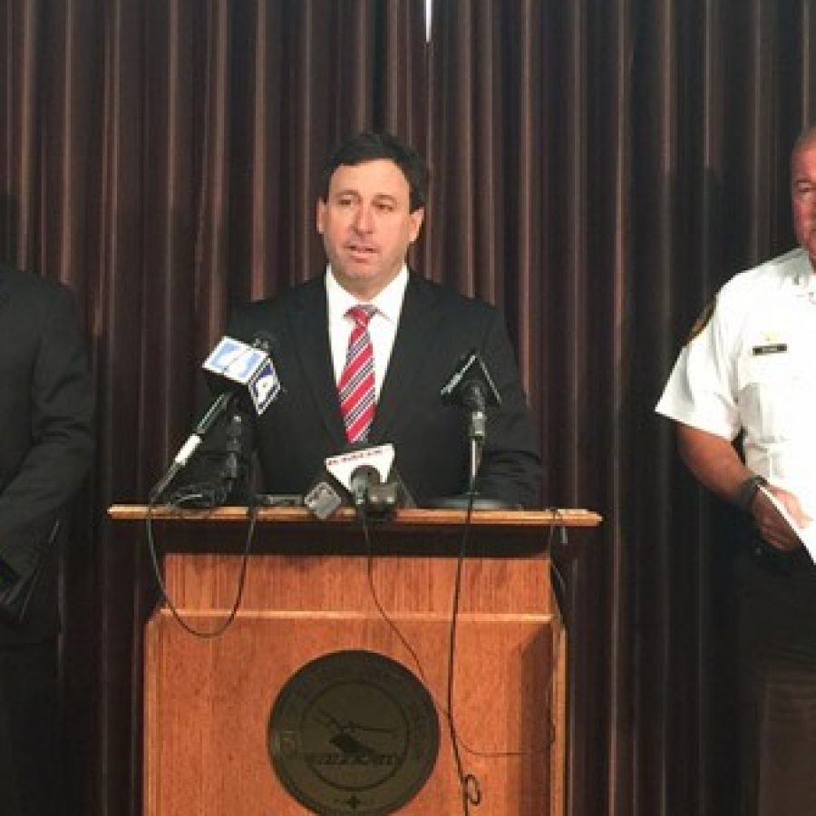 County Executive Steve Stenger announces higher police salaries June 22 along with St. Louis County Fraternal Order of Police President Joe Patterson, left, and police Chief Jon Belmar.