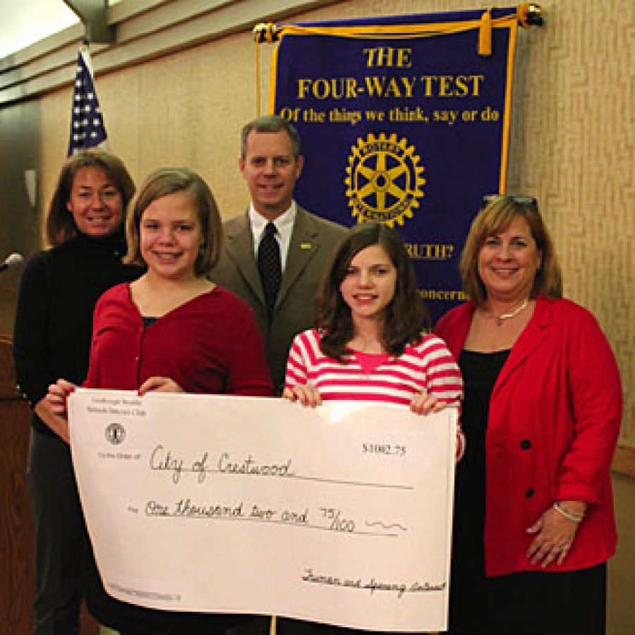 Truman Middle School sixth-grader Emma Deutschmann, left, and Sperreng Middle School seventh-grader Katie Spradling present a donation to Crestwood Mayor Jeff Schlink at the Dec. 22 Crestwood Sunset Hills Rotary Club meeting. They are joined by club sponsors Jane Hake, right, and Debbie Schiavo, left.