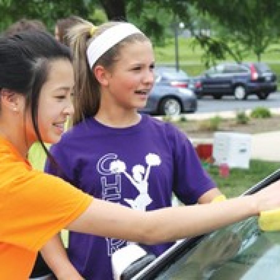 Seventh-graders participating in the car wash included Alena Hong, left, and Libby Uttendorf. 
 