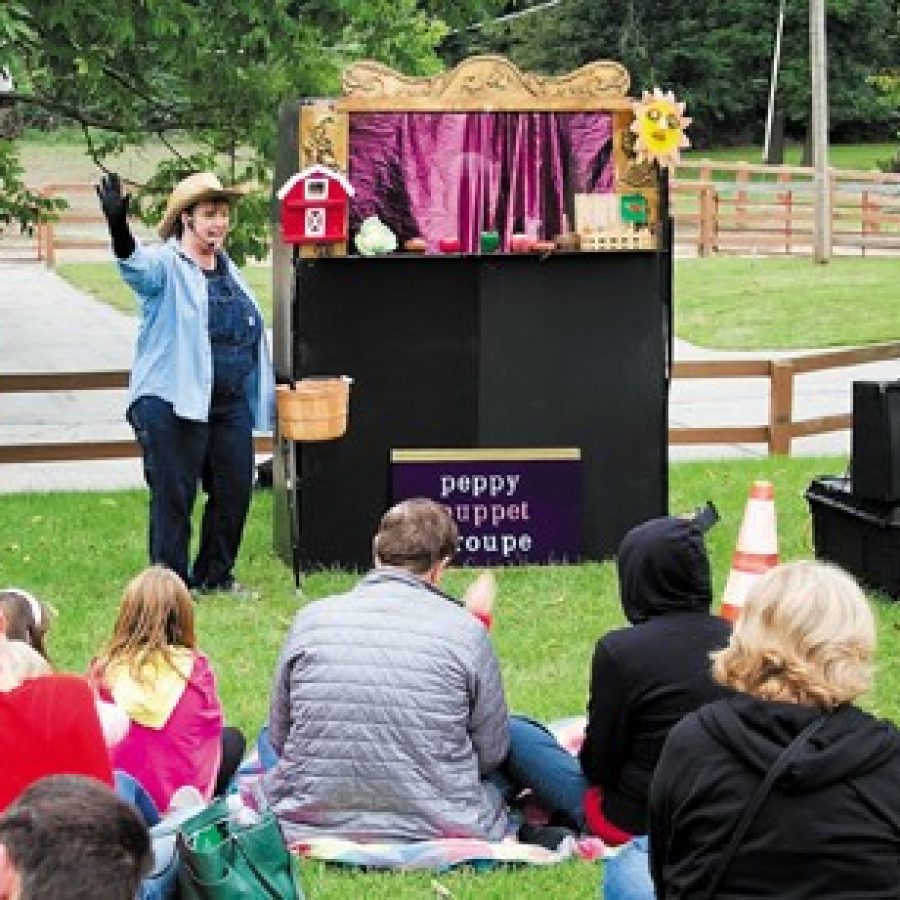 Above, children and their parents enjoy a performance by the Peppy Puppet Troupe last Friday afternoon.