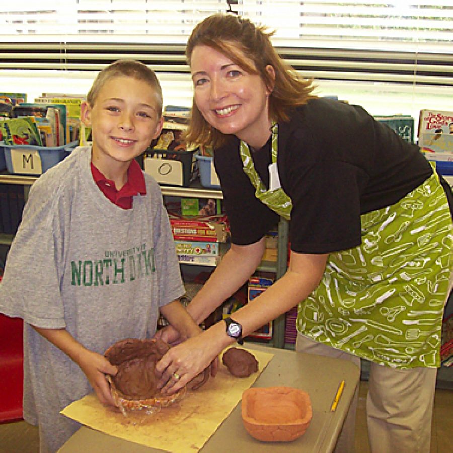 Callum and Ashlyn Cunningham show off one of the the handmade bowls they created for Green Park Lutheran Schools Empty Bowls Project last year. The school will sponsor its second annual Empty Bowls luncheon and dinner event today — Nov. 11 — to raise money to help the hungry in this community.