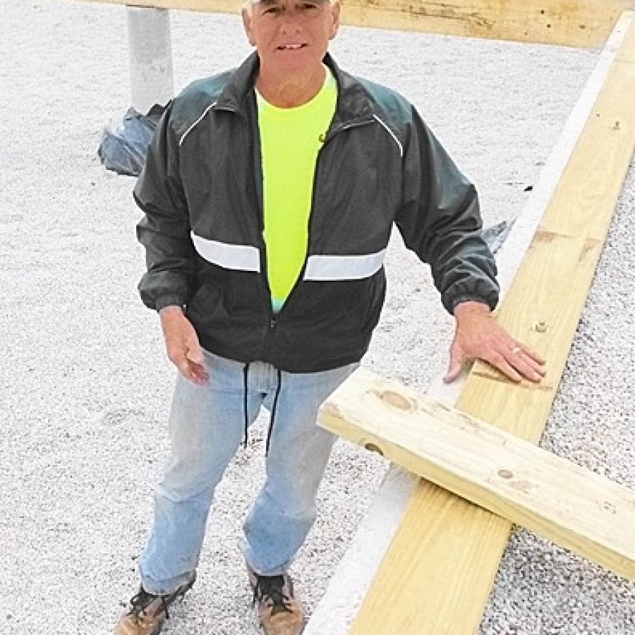 Charlie Keller of the Queen of All Saints St. Louis Sluggers inspects the foundation of a Habitat for Humanity home before his crew starts to construct the flooring system.