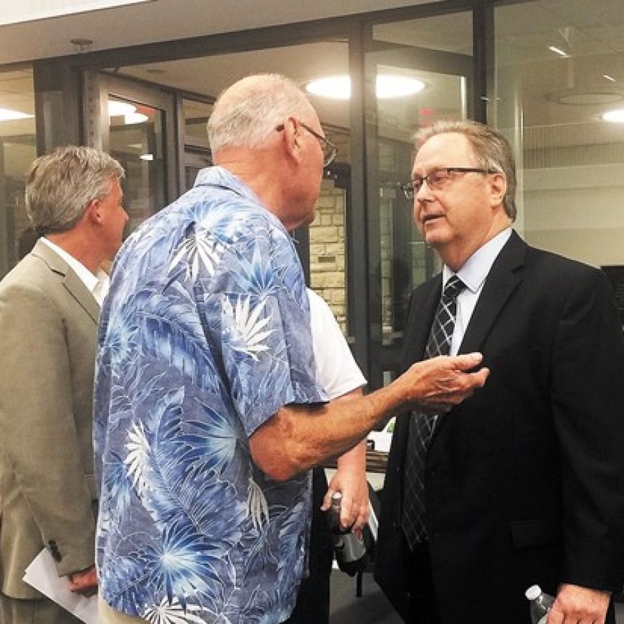 Sixth District County Councilman Kevin OLeary, D-Oakville, right, talks to a veteran after a public hearing last week on whether to sell part of Sylvan Springs Park to expand Jefferson Barracks National Cemetery. Pictured in the background is River City Casino General Manager Chris Plant, left.