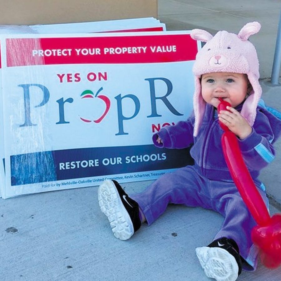 Mehlville School District students decorated T-shirts and cars at a mini-rally in support of the districts Nov. 3 ballot measure, Proposition R for Restore, at Mehlville High Saturday, the same day residents set out their yard signs for and against the measure. Pictured above at the rally is Mariska Stormer, 1, daughter of Board of Education Secretary Samantha Stormer.