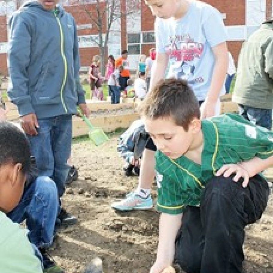 Working on the new Bierbaum Elementary community garden, from left, are: students Keshon Scott, Malik Smajic and Teo Juricic.
